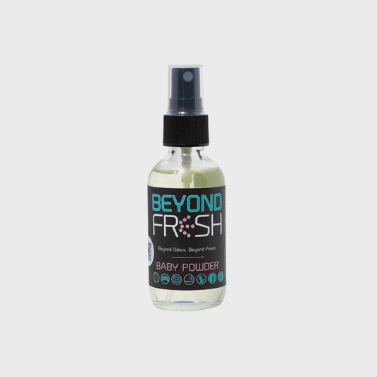 Bottle of 'Beyond Fresh' Baby Powder scented spray on a white background.