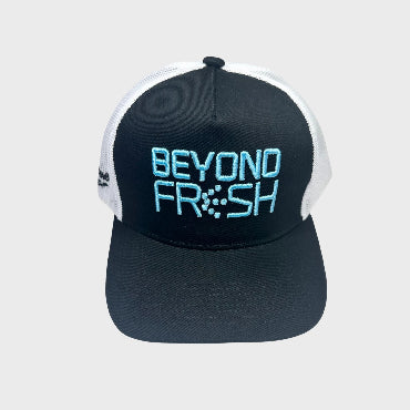 Front side of black and white cap with light blue 'Beyond Fresh' branding on a white background