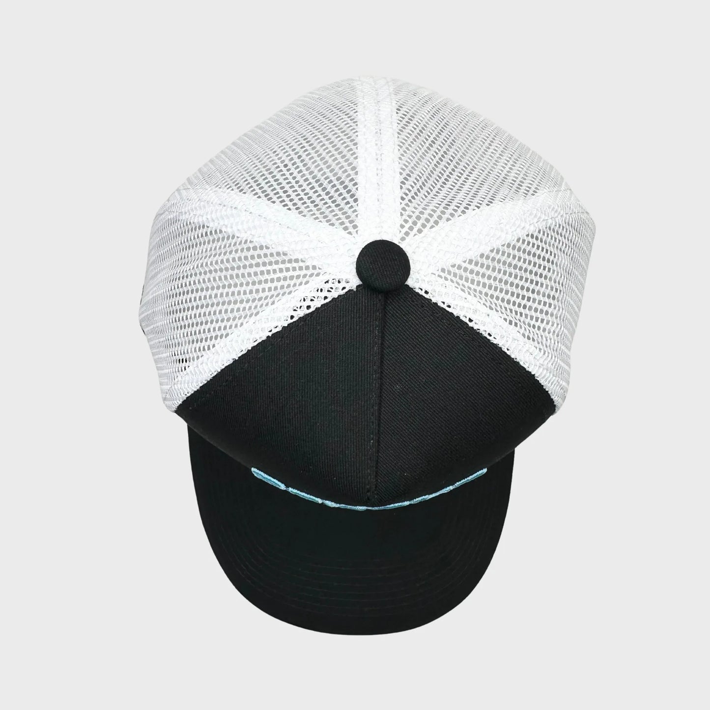 Black and white cap with mesh back on a light gray background