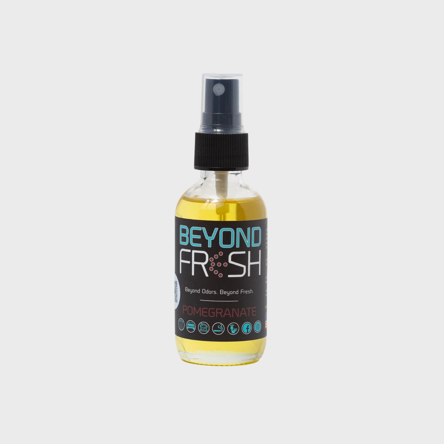 Bottle of 'Beyond Fresh' Pomegranate scented spray on a white background.