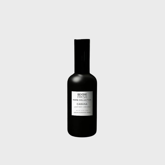 100 ml black bottle of Home Collection Room Spray, Cabana scent on white background.