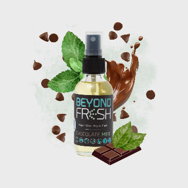 Bottle of 'Beyond Fresh' Chocolate Mint scented spray with chocolate chips and mints on a white background.