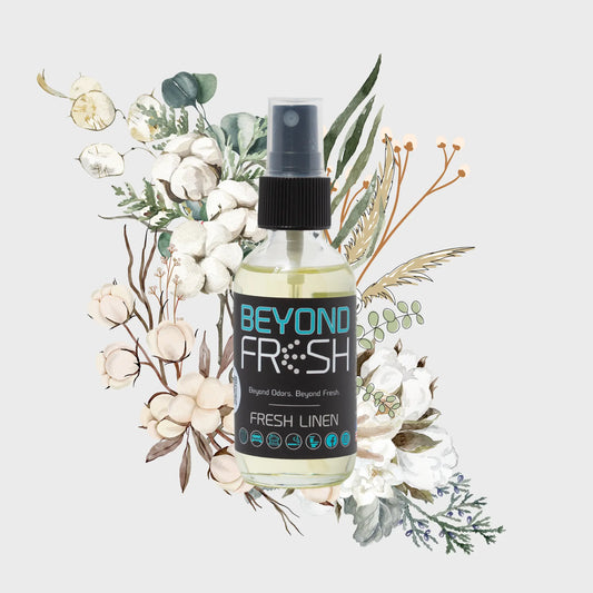 Bottle of Fresh Linen scent with floral and leaf decorations on a light background