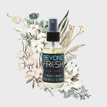 Bottle of Fresh Linen scented spray with floral and leaf decorations on a white background.