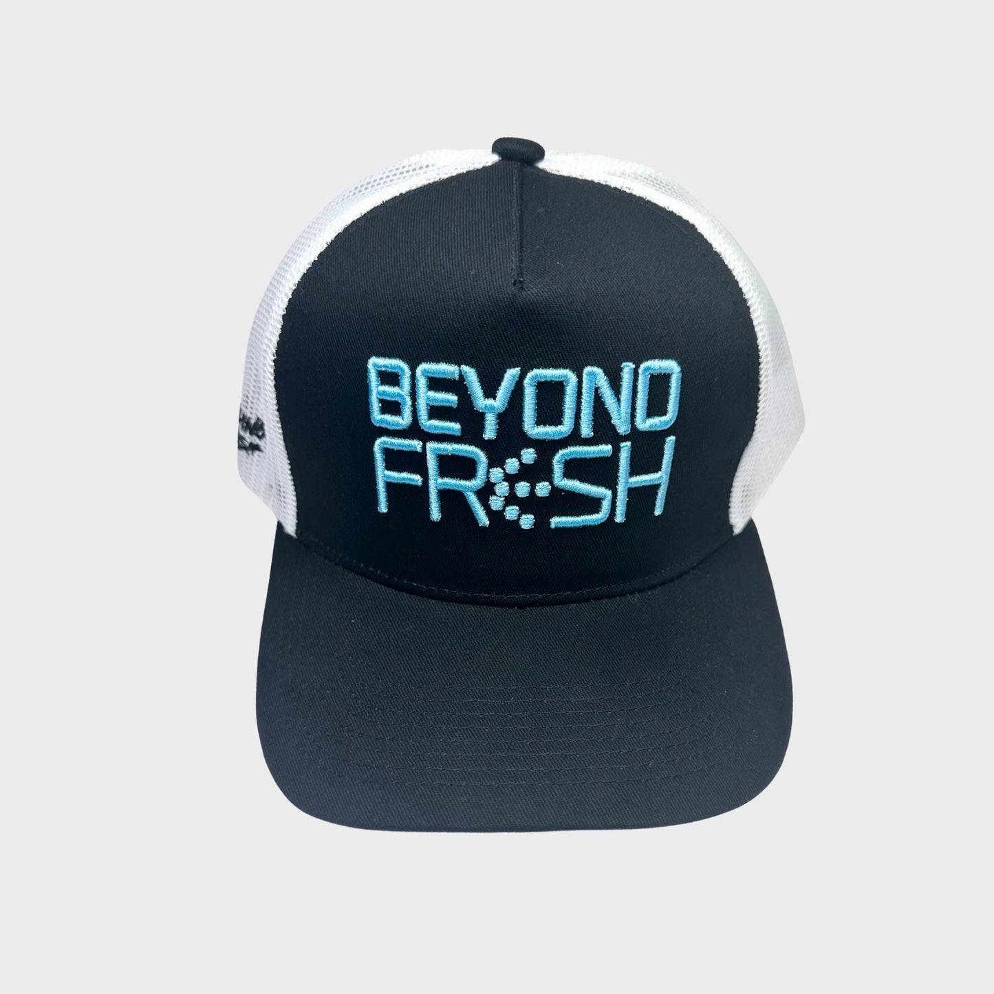 Black and white cap with Beyond Fresh text on a light gray background