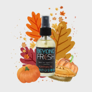 Bottle of 'Beyond Fresh' Pumpkin Pie scented spray with colorful pies on a white background.