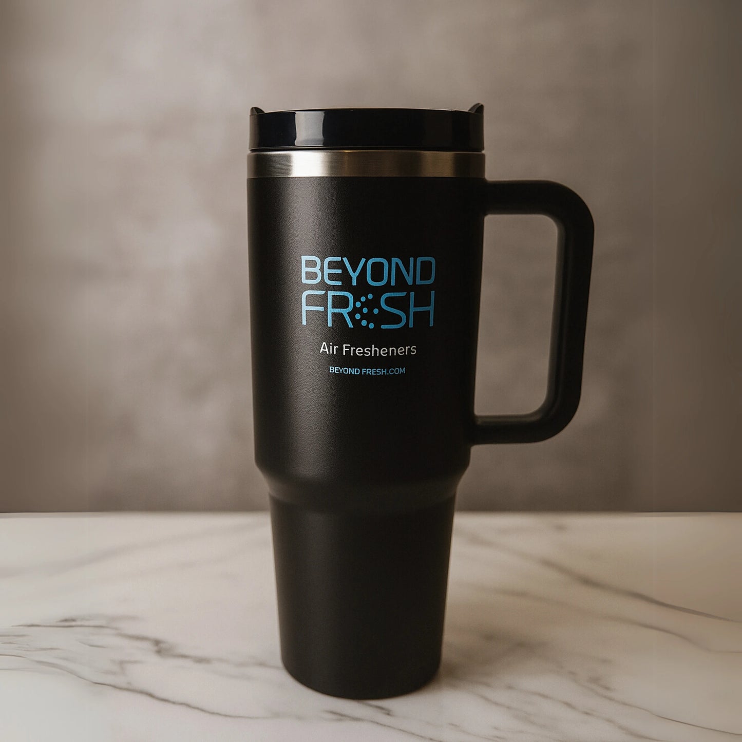 Black travel tumbler with 'Beyond Fresh' branding on a marble surface.