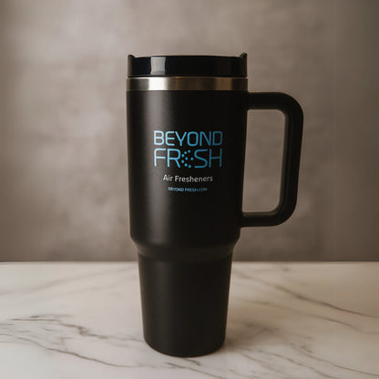 Black travel tumbler with 'Beyond Fresh' branding on a marble surface.